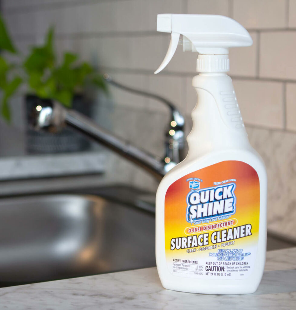 Quick Shine® 3-IN-1 Disinfectant Surface Cleaner sitting on kitchen countertop next to sink