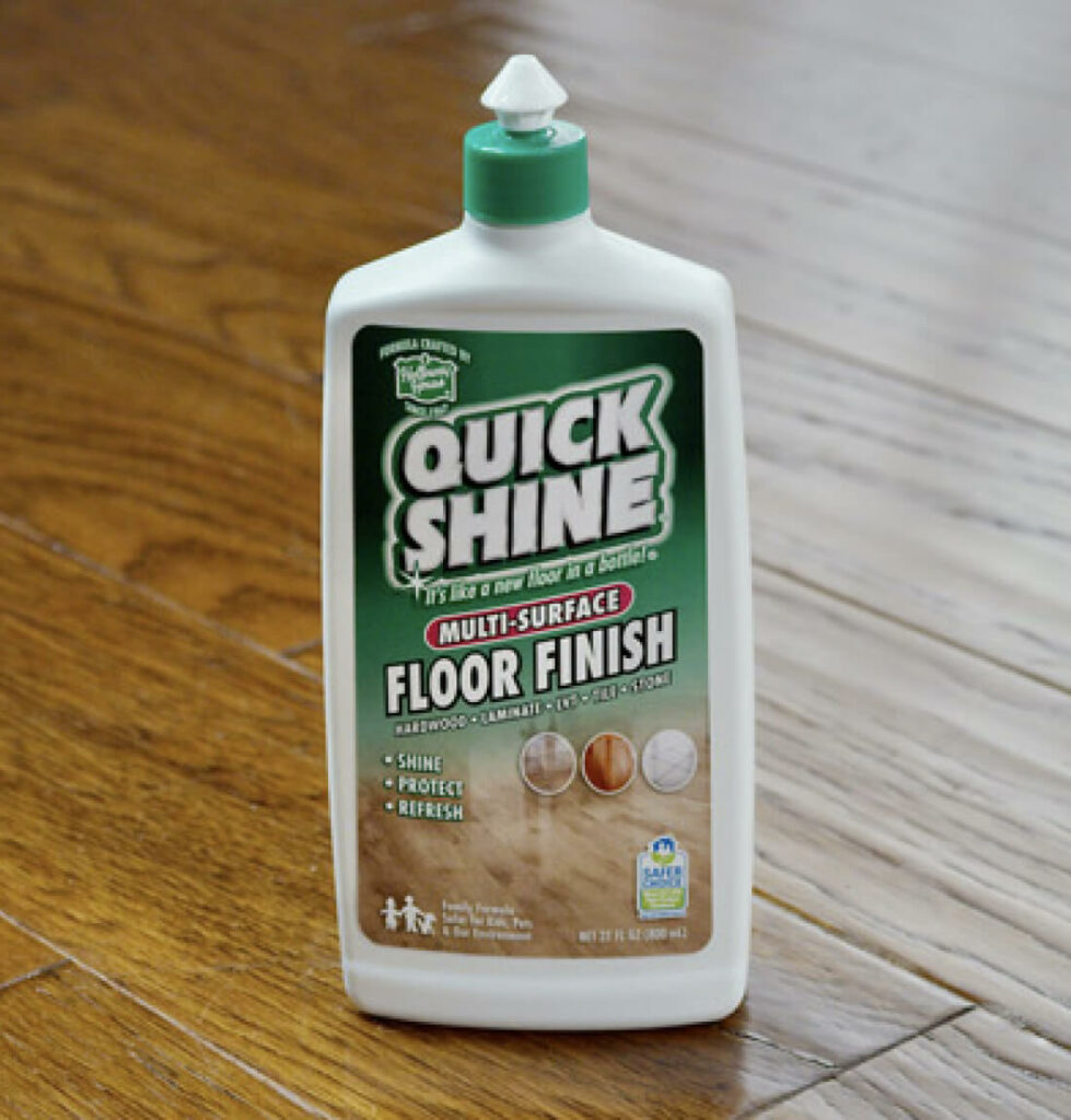 Quick Shine® Floor Finish bottle sitting on wood floor