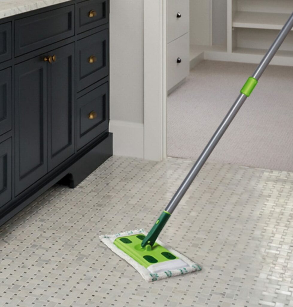 Quick Shine® Hard Surface Floor Mop leaning against wall in bathroom